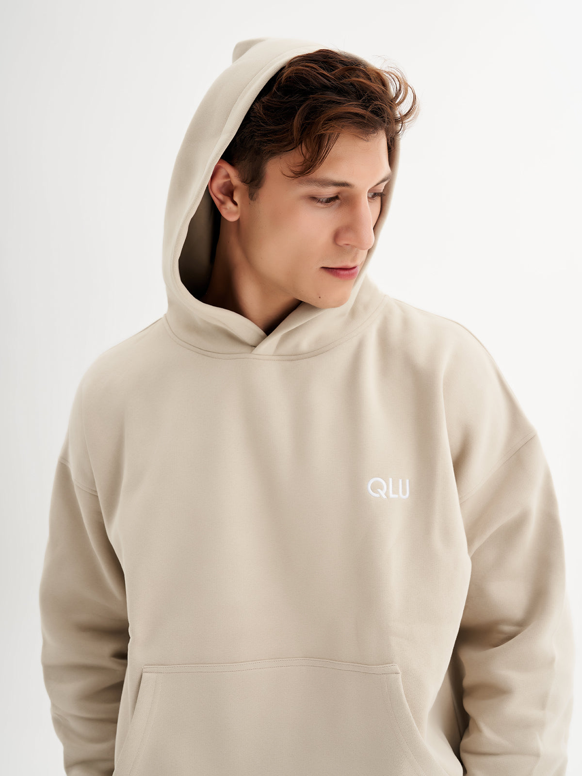 a young man wearing a hoodie with the word ouu on it