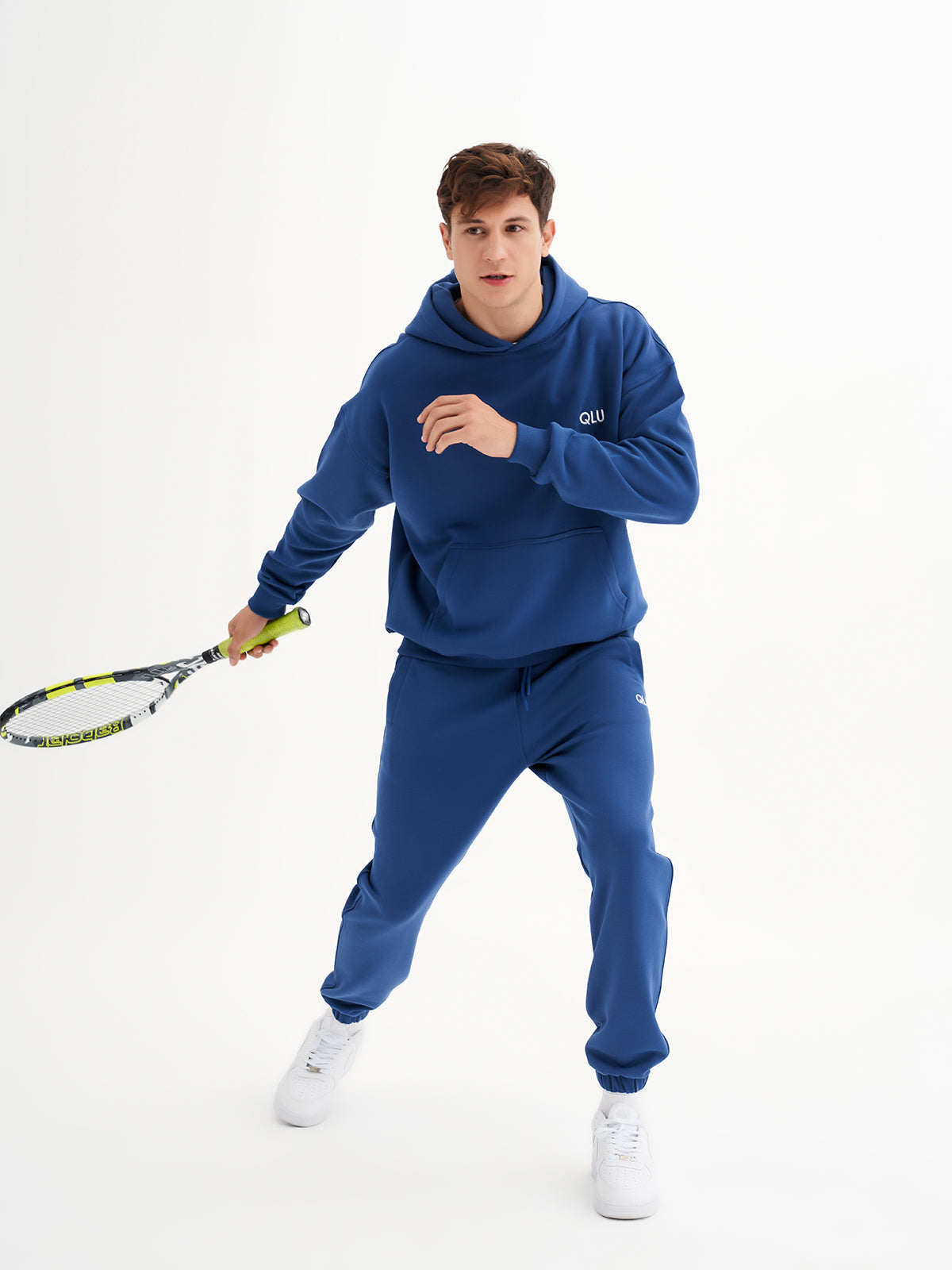 a man holding a tennis racquet on a white background