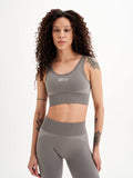 a woman in grey sports bra top and leggings