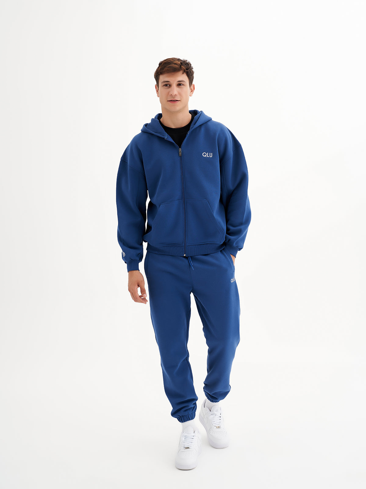 a young man wearing a blue sweat suit