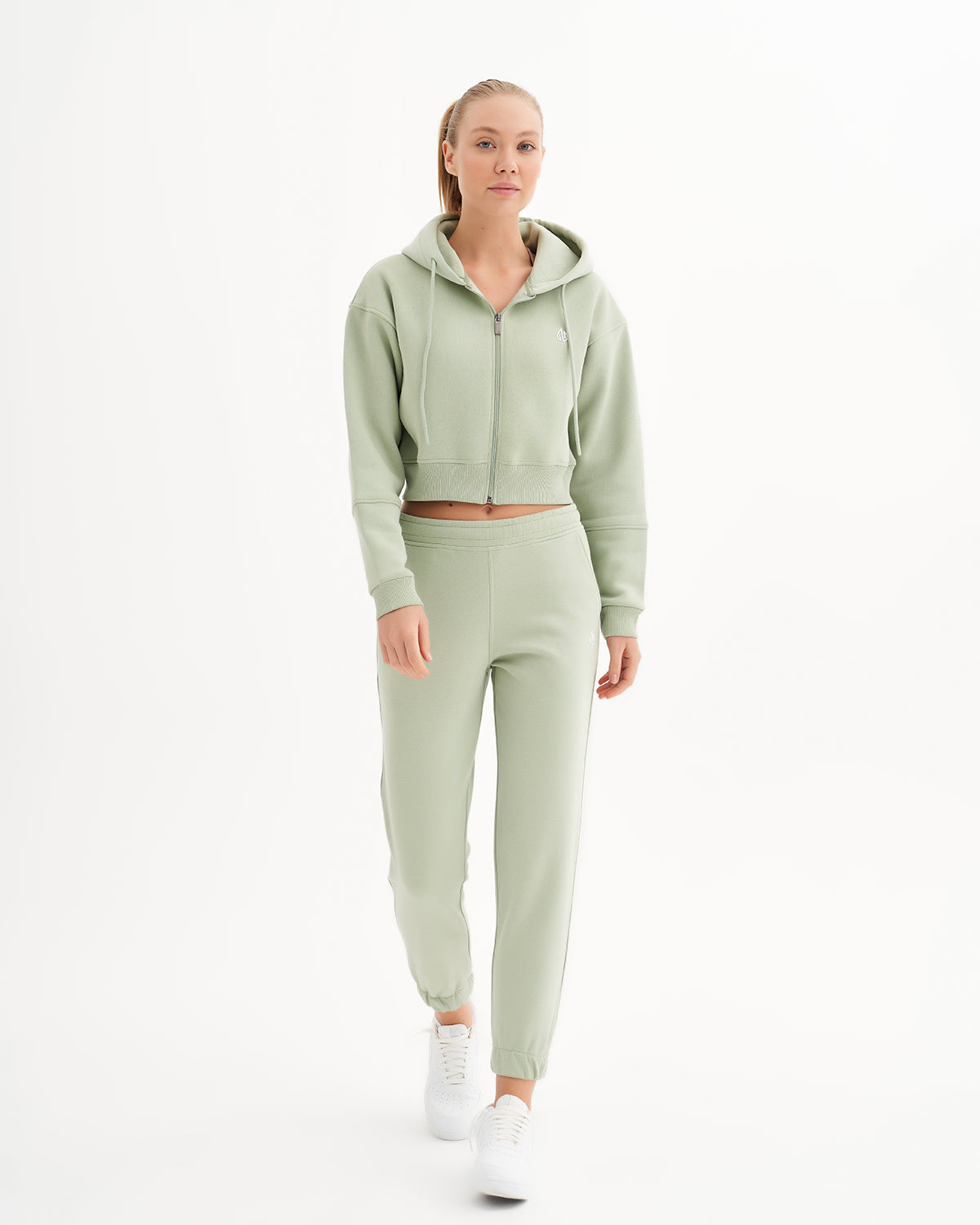 a woman in a light green sweat suit