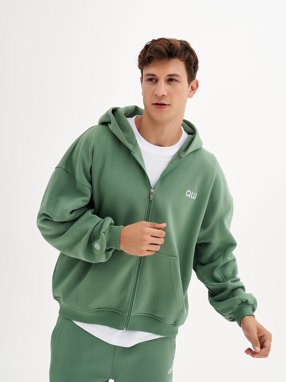 a man in a green hoodie is posing for a picture