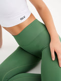 a close up of a person wearing green leggings