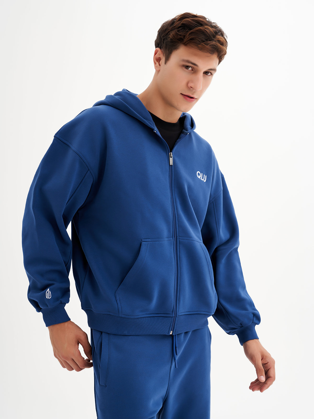 a young man in a blue sweat suit