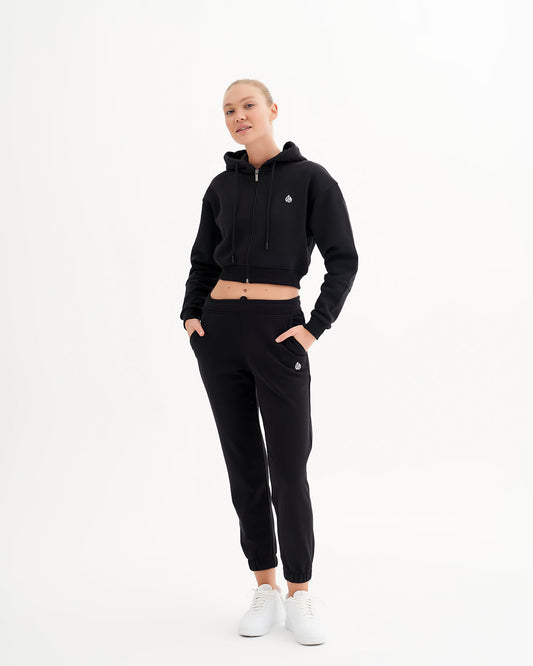 a woman in a black hoodie and sweatpants