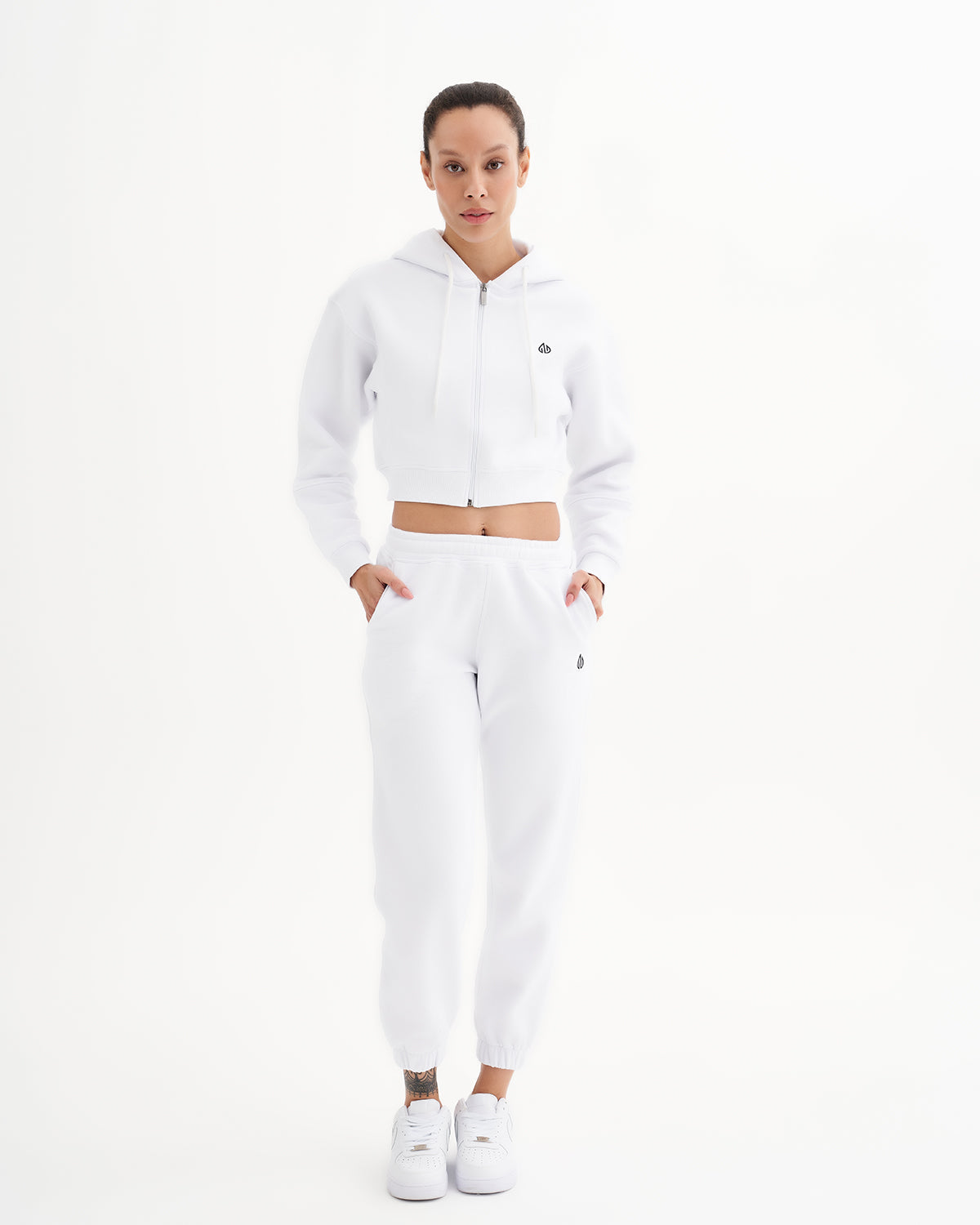 a woman in a white crop top and sweatpants