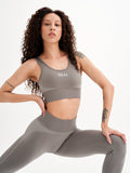 a woman in grey sports bra top and leggings