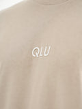 a white t - shirt with a qlu logo on it