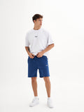 a man in a white t - shirt and blue shorts