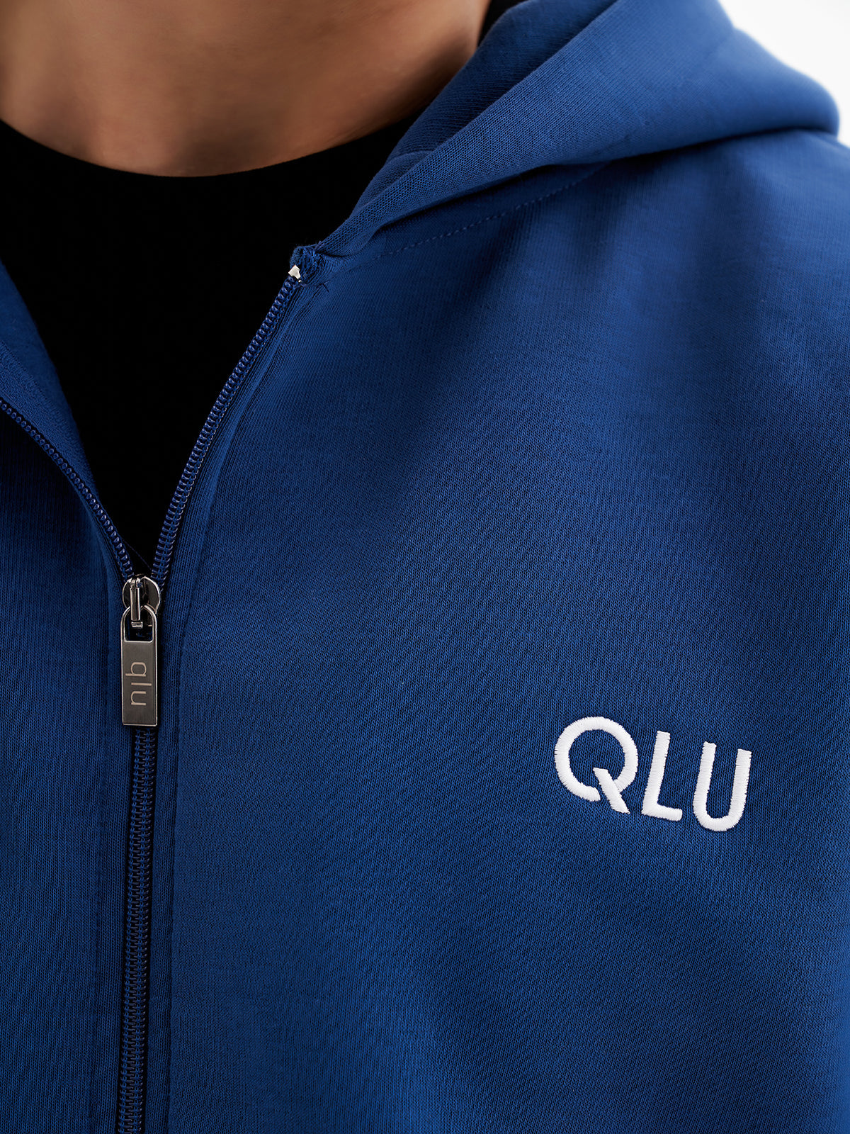 a close up of a person wearing a blue hoodie