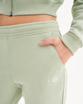 a close up of a person wearing a green sweatpants