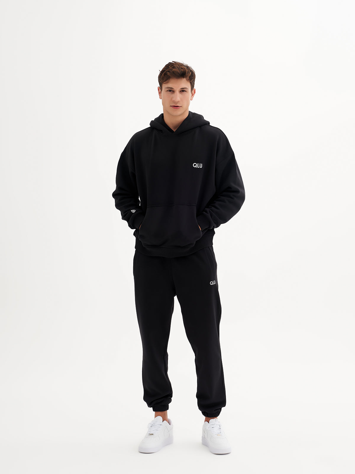 a man in a black hoodie and sweatpants