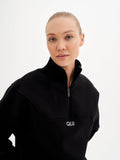 a woman in a black sweatshirt with the word ouu on it