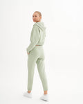 a woman in a light green sweat suit