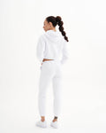 a woman in a white sweatshirt and pants