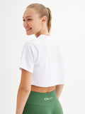 a woman in a white shirt and green shorts