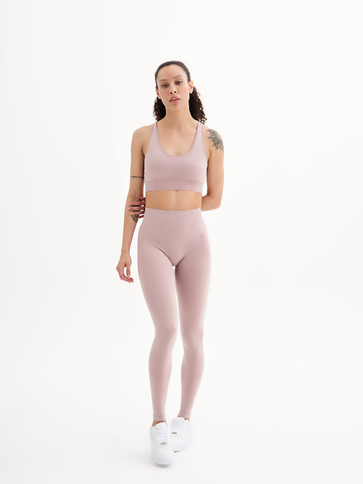 a woman in a pink sports bra top and leggings