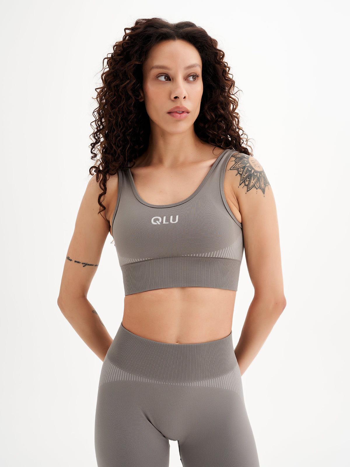 a woman in grey sports bra top and leggings