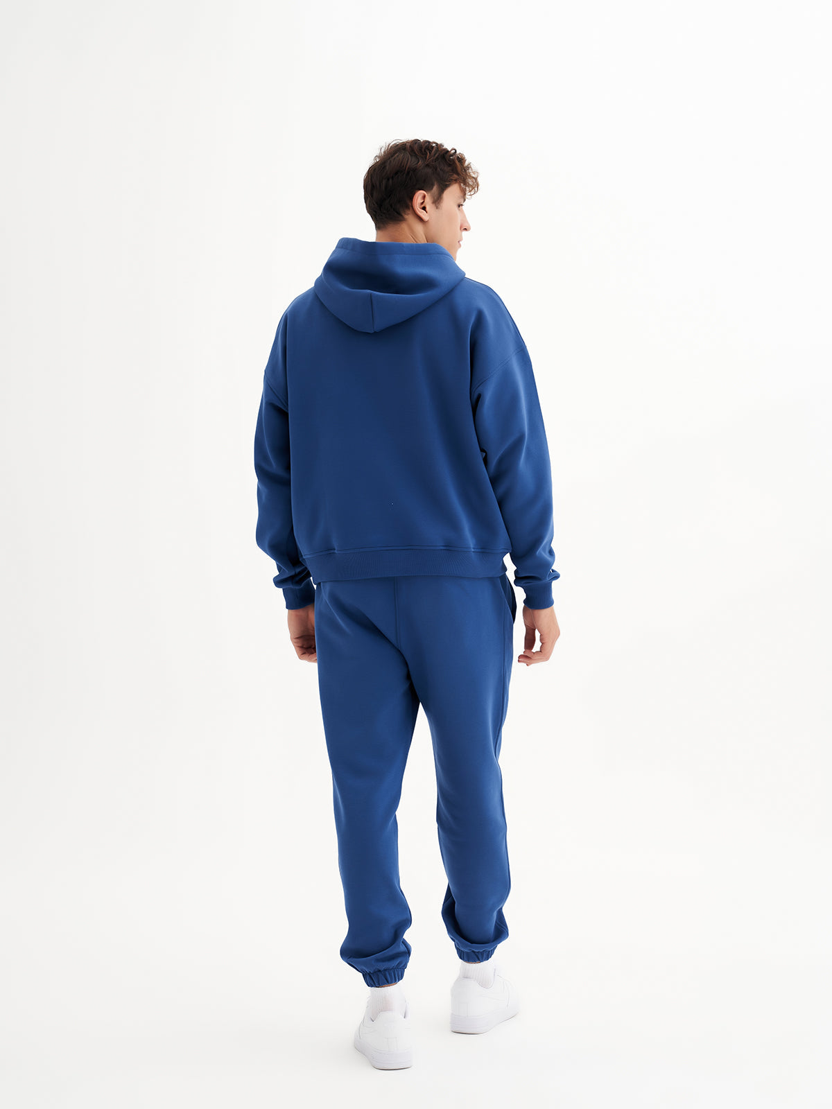 a man in a blue sweatshirt and sweat pants