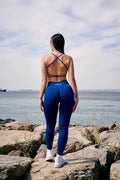 a woman standing on a rock near the ocean